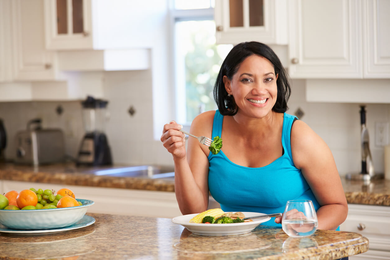 Woman Eating Healthy Meal in Kitchen