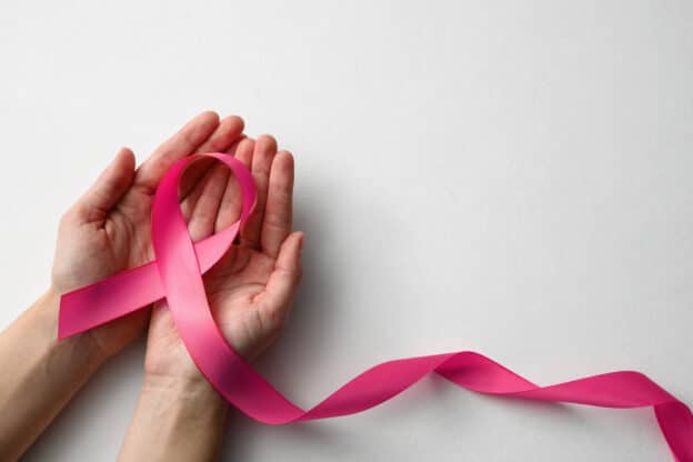 Breast cancer awareness; hands holding ribbon