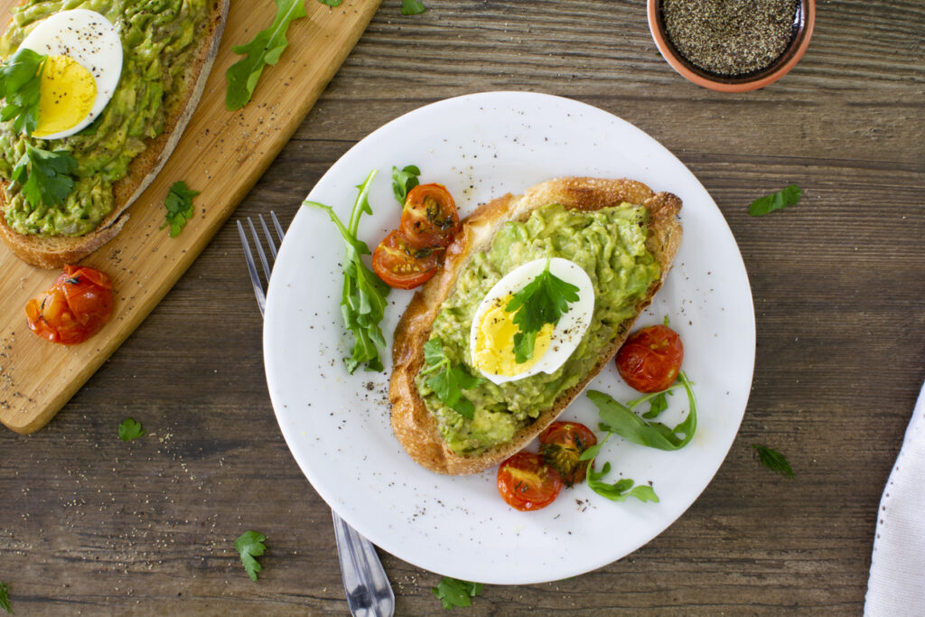 Avocado toast with eggs and roasted tomatoes