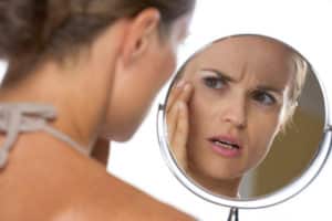 Woman looking in mirror