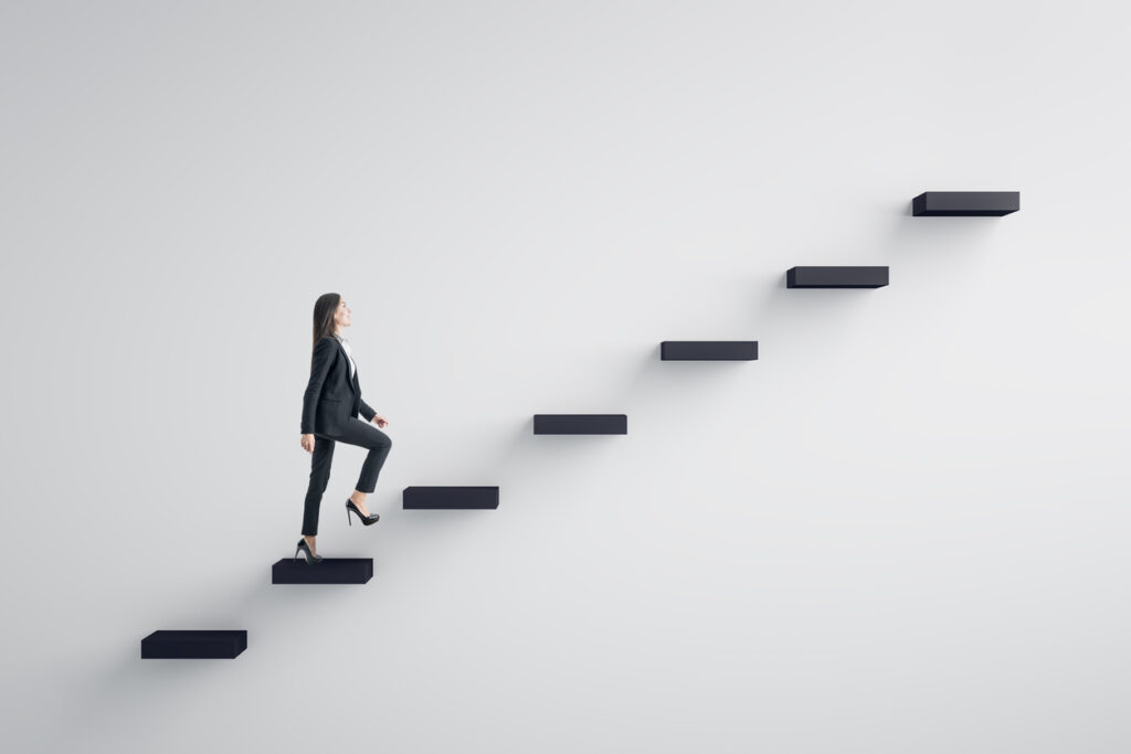 Woman climbing stairs or a corporate ladder - types of leadership