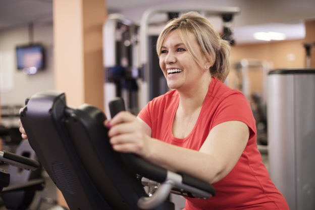 Woman working out on a stairmaster to counteract overeating