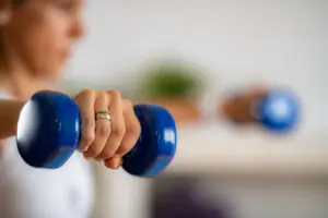 Woman Exercising with Dumbbells. Exercises for Toned Arms