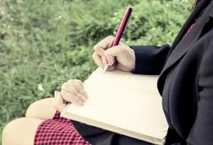 Lady writing in journal
