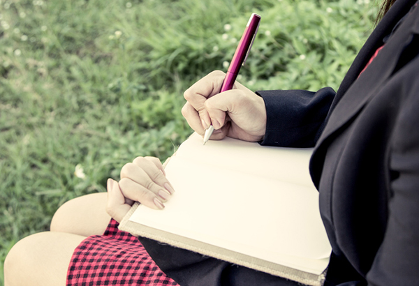 Lady writing in journal