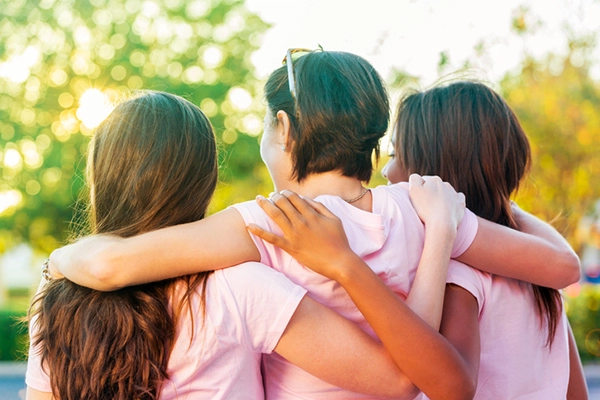 3 girls hugging each other