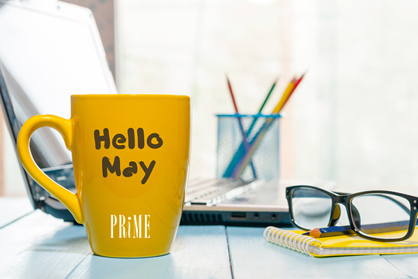 yellow coffee mug with month of May written on it