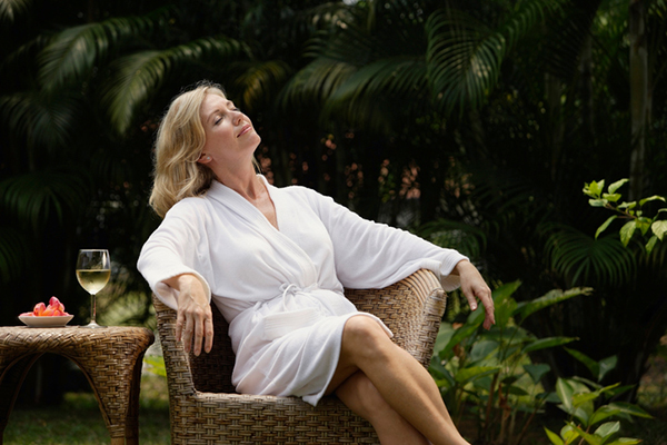 woman sunbathes - wellness retreats