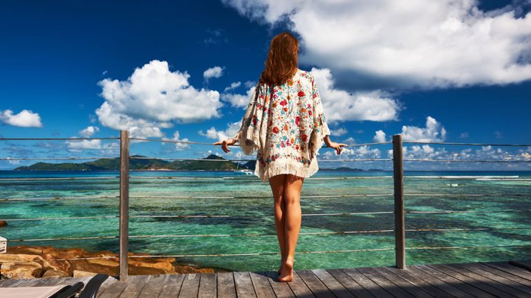Woman in a caftan standing on a pier