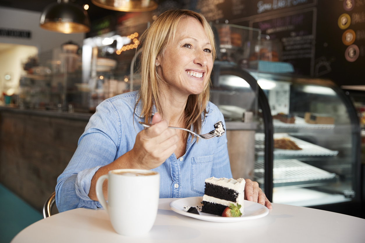 Woman Eating Slice of Cake