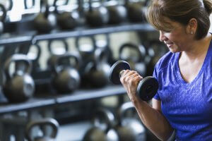 Woman Lifting Weight to help with gaining muscle after 50