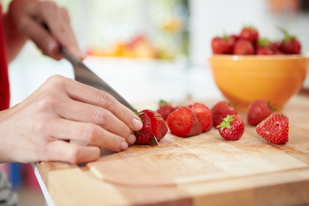 Woman Cutting Strawberries