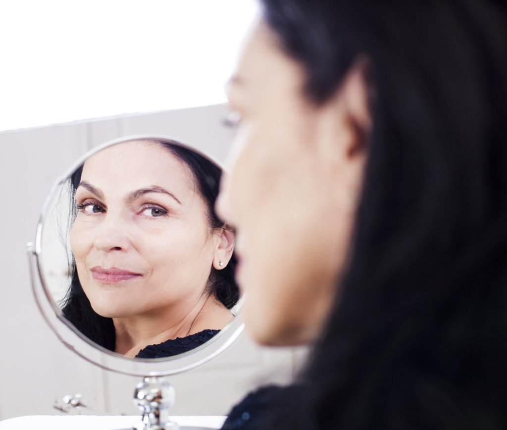 Woman Looking in Mirror
