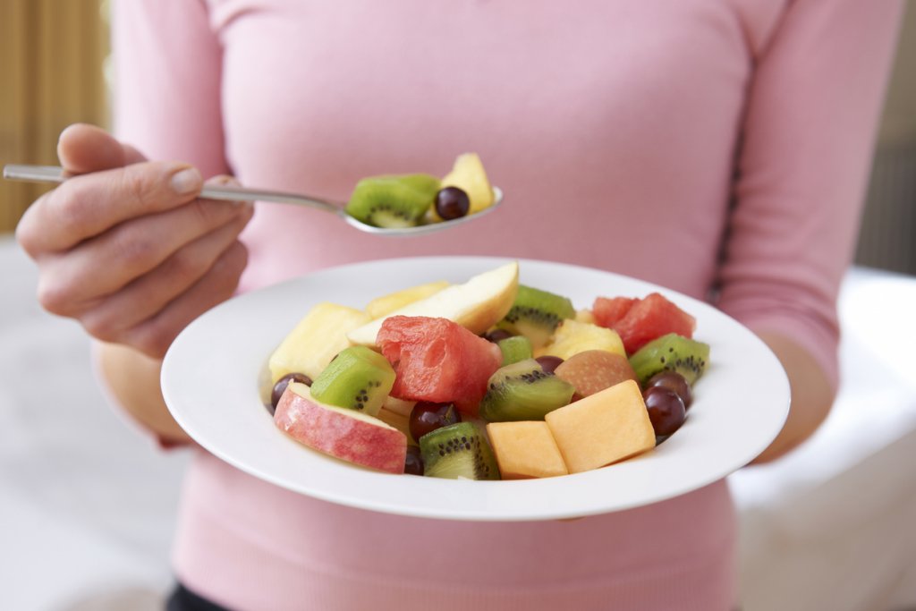 Woman Eating Fruit