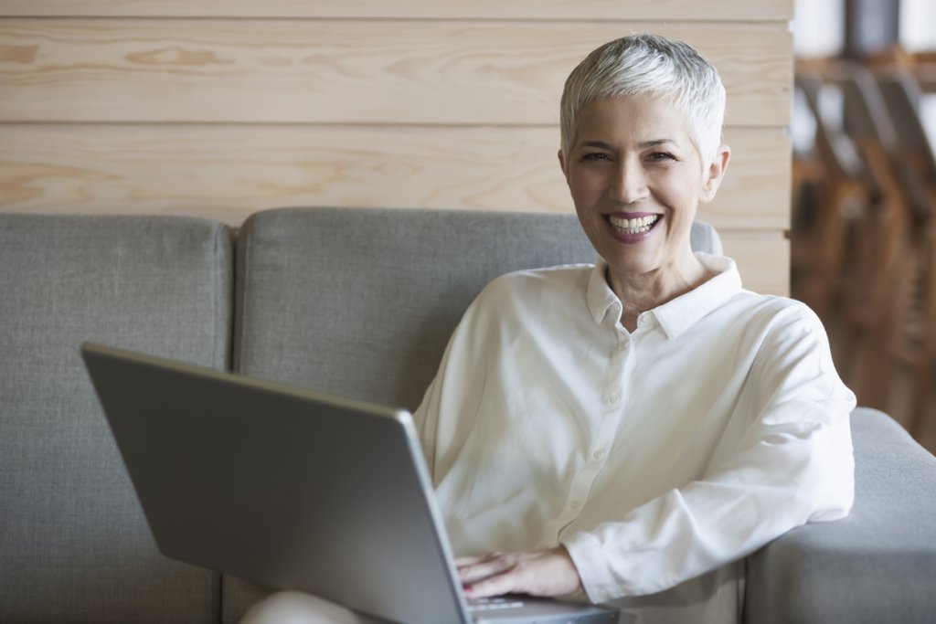 Woman working on laptop at cafe