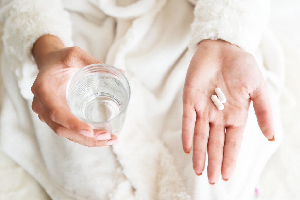 Woman Taking Supplement how much fiber per day
