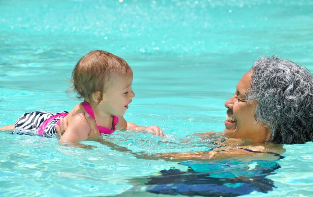Woman Swimming with Grandchild