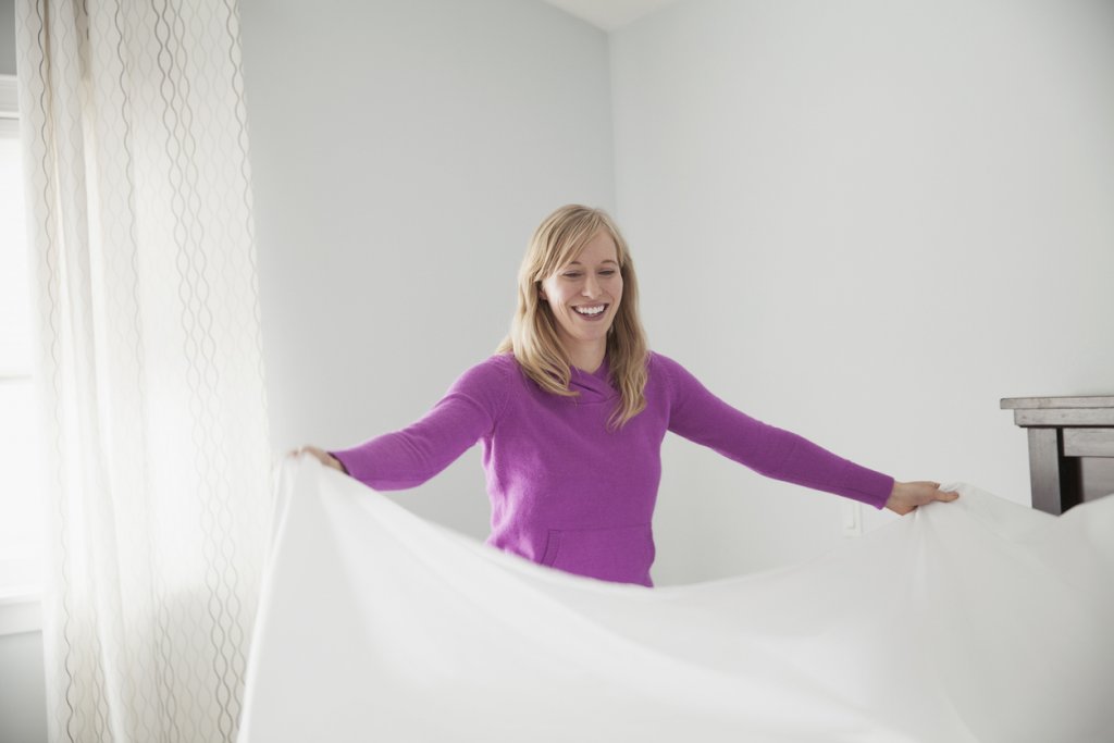 Mature Woman Making a Bed