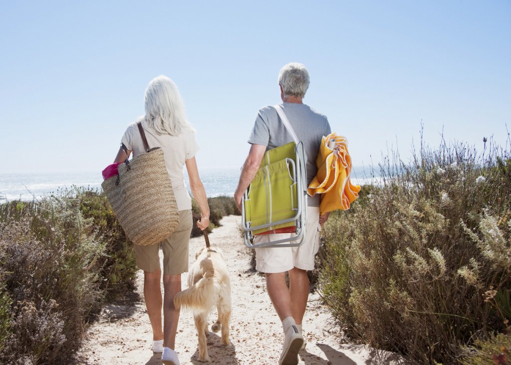 Mature Couple Holding Beach Bags