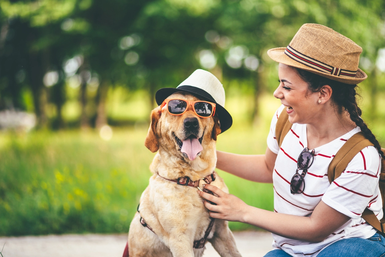 Dog and woman wearing cool summer accessories