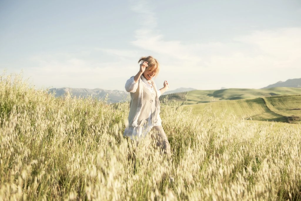 women inspiring women Woman running in grassy field