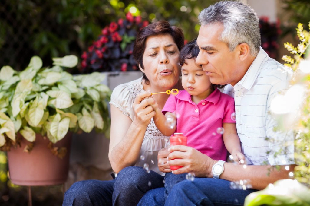 GRANDPARENTING TIPS Grandparents and granddaughter making bubbles