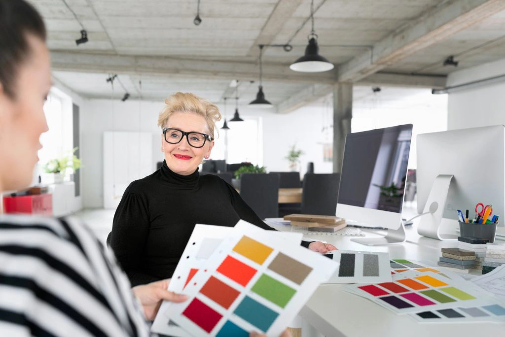 Women Supporting Women Senior and young interior designers working together in the office