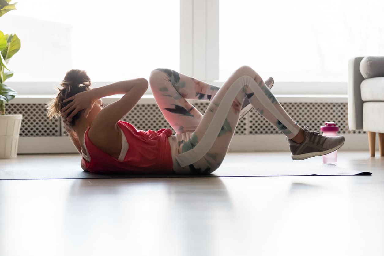 Woman doing criss cross or bicycle crunch for core exercises