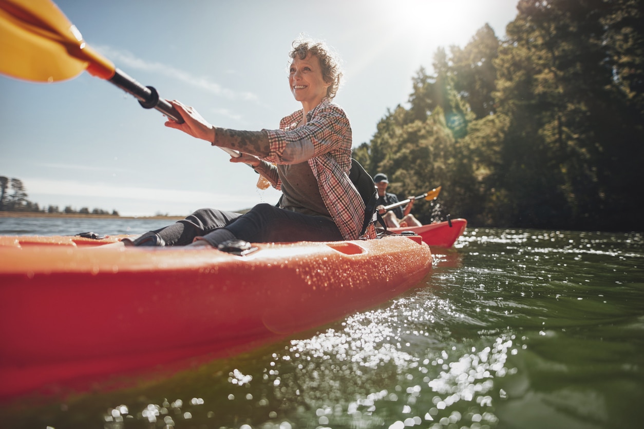 Senior woman kayaking and embracing adventure