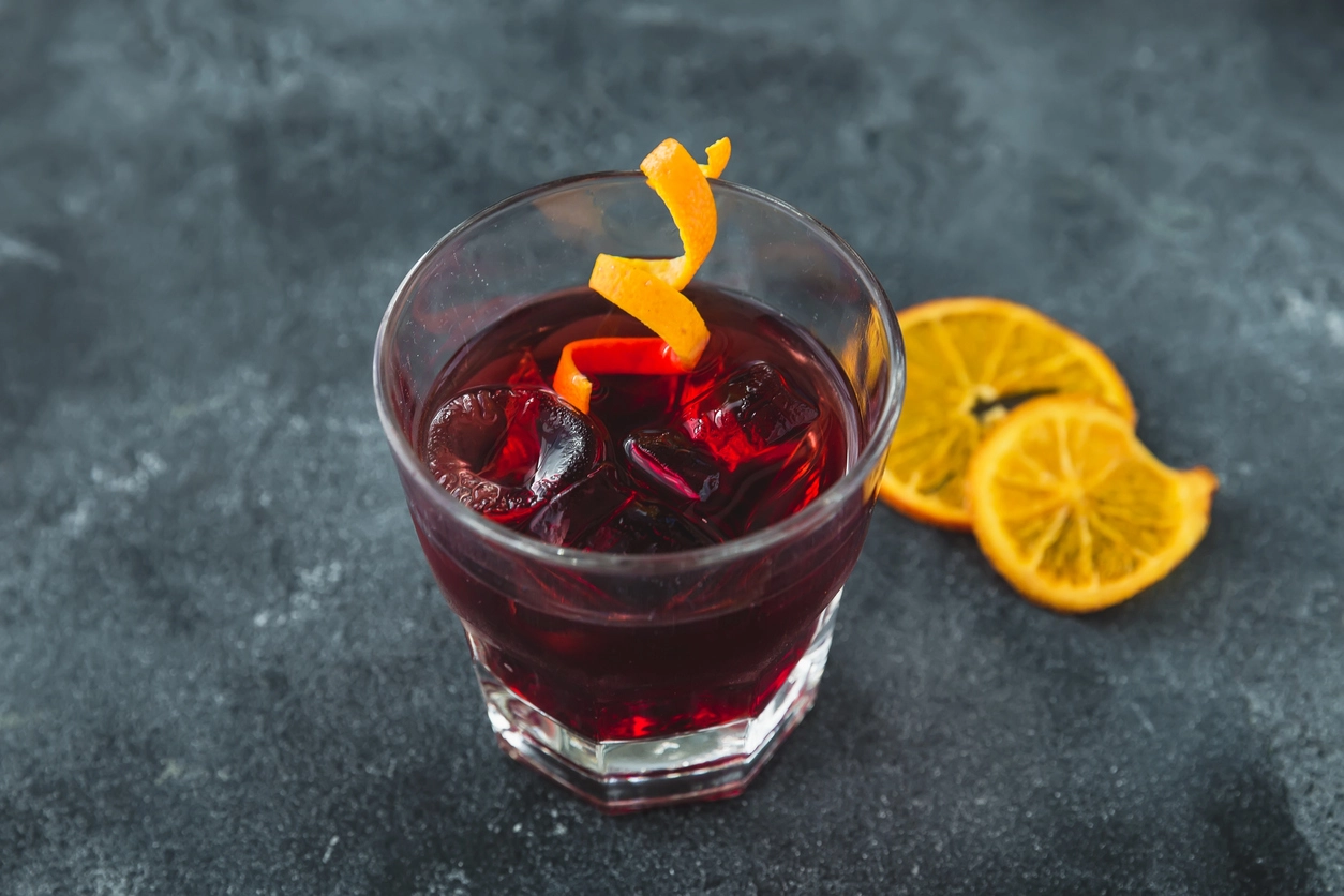 Alcoholic cocktail with orange. Alcoholic cold drink in bar