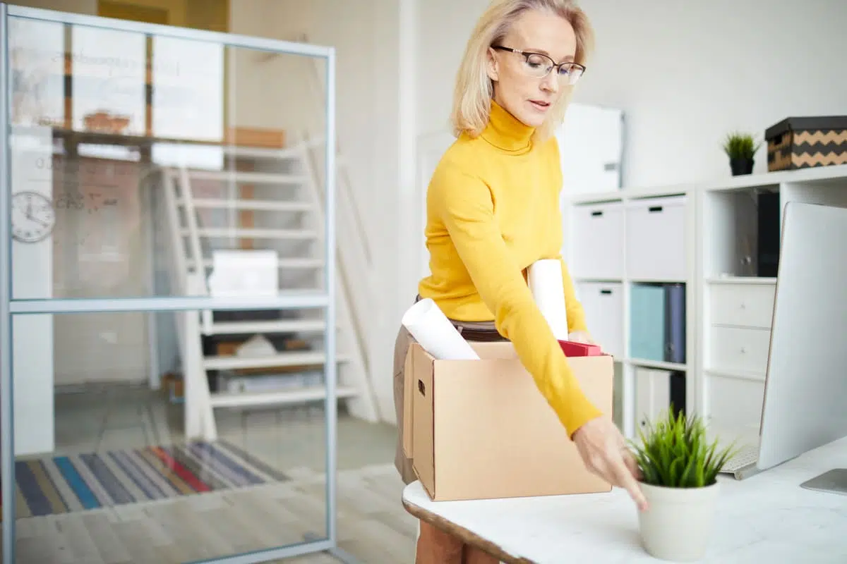time to move on - woman packing up her desk, career change