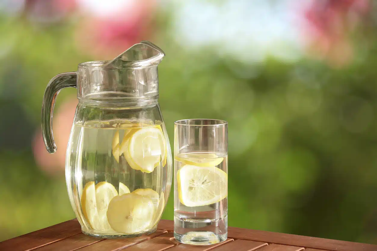Water pitcher and glass with lemon