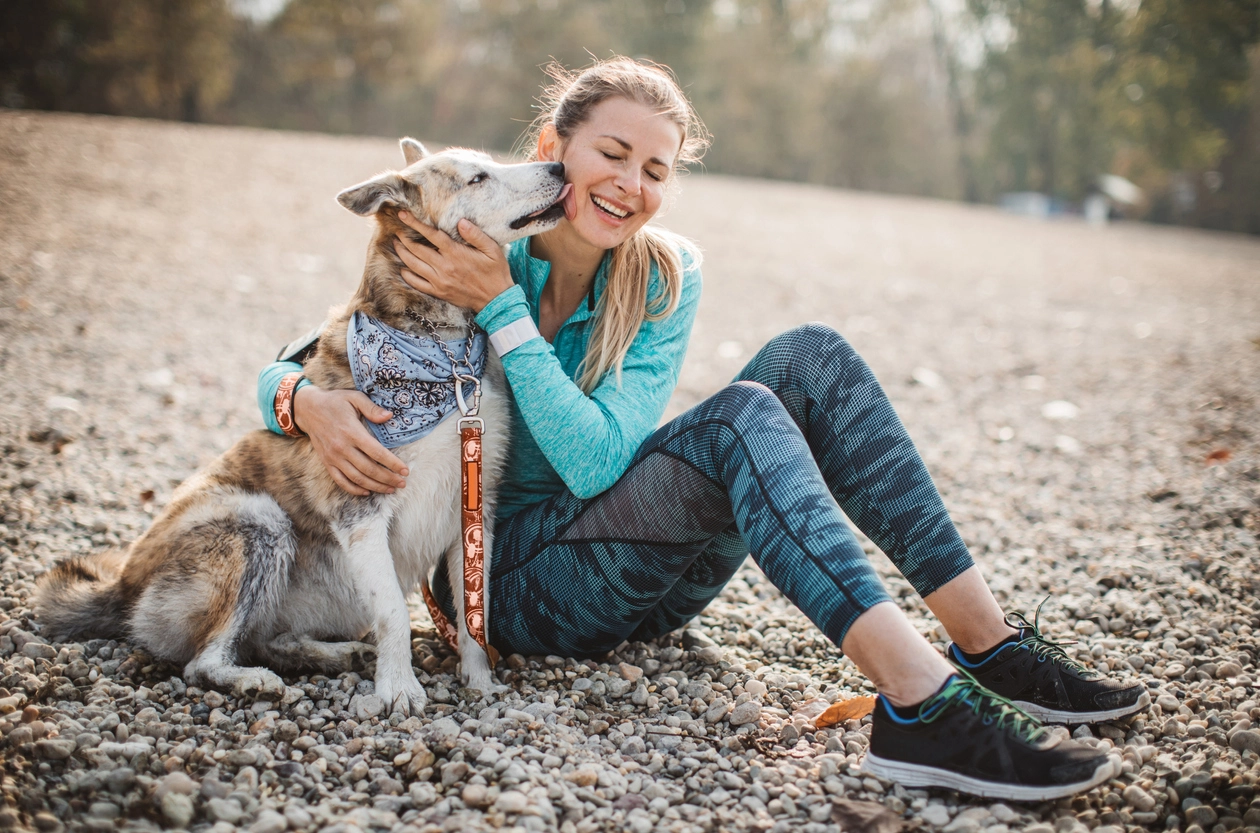 Woman resting on beach with dog