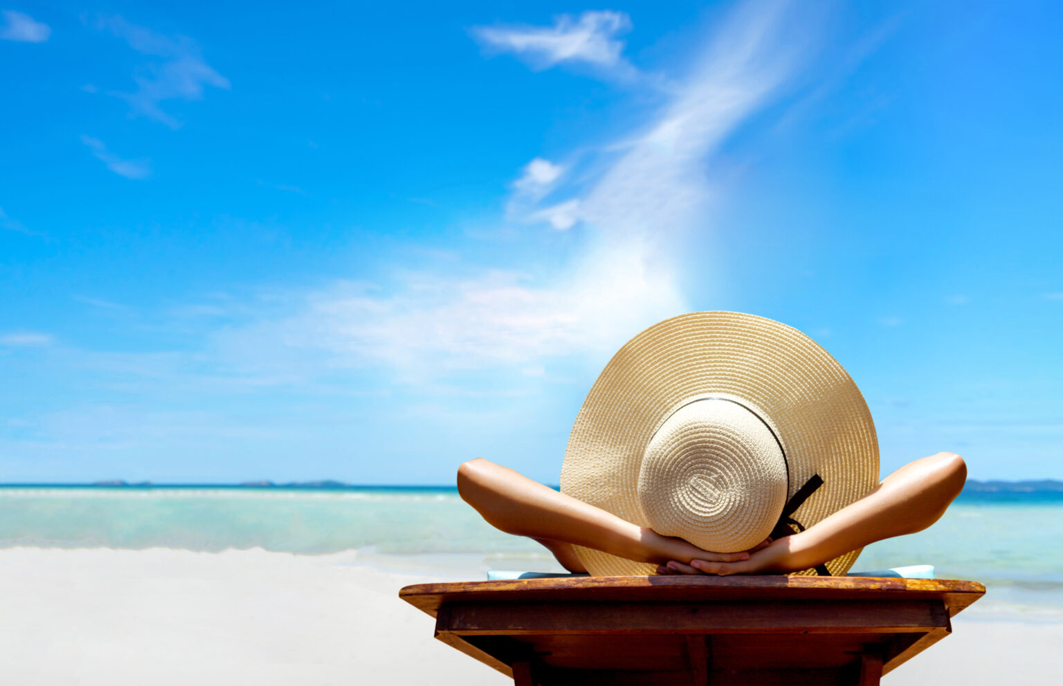 Woman wearing a sun hat by the ocean