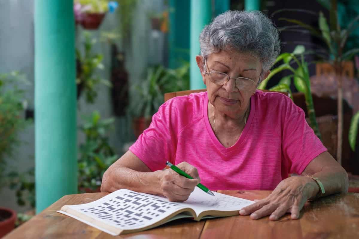woman sitting doing crossword puzzles
