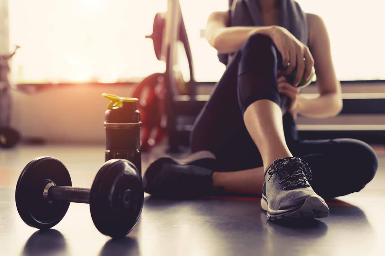 Working out - Woman at the gym with dumbbells; Muscle Matters