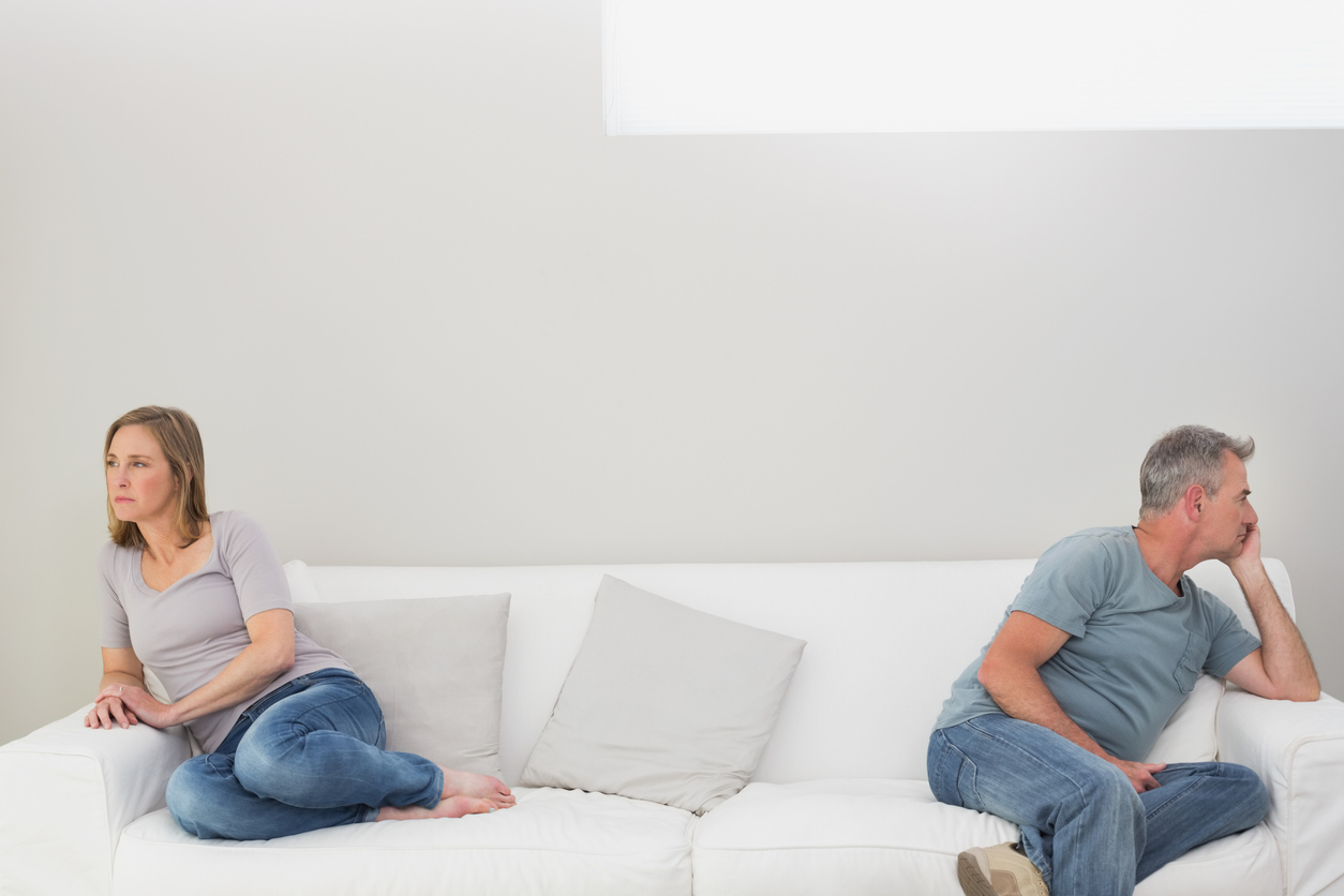 Couple on a couch not talking or communicating with each other