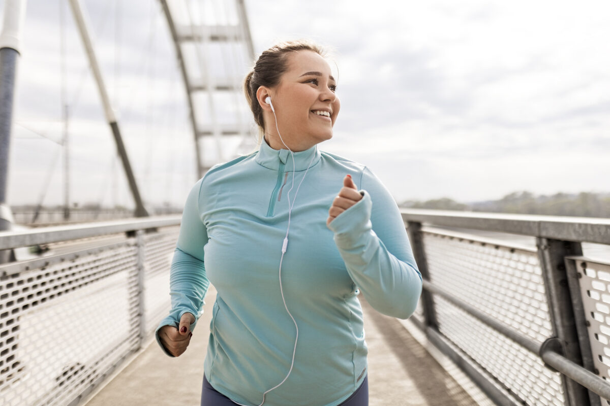 Happy woman running on a bridge