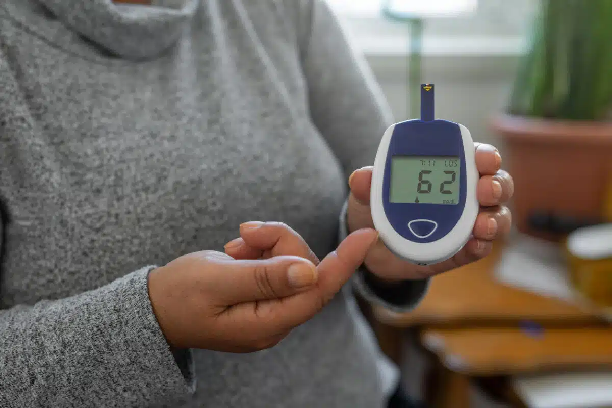 Metabolic health and woman checking blood sugar
