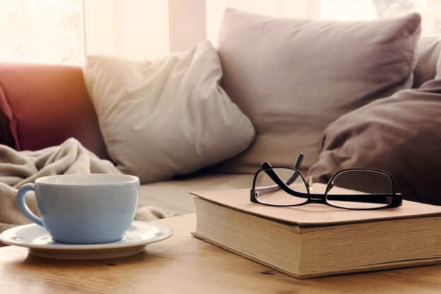 Books for the new year, reading glasses on a book and the couch