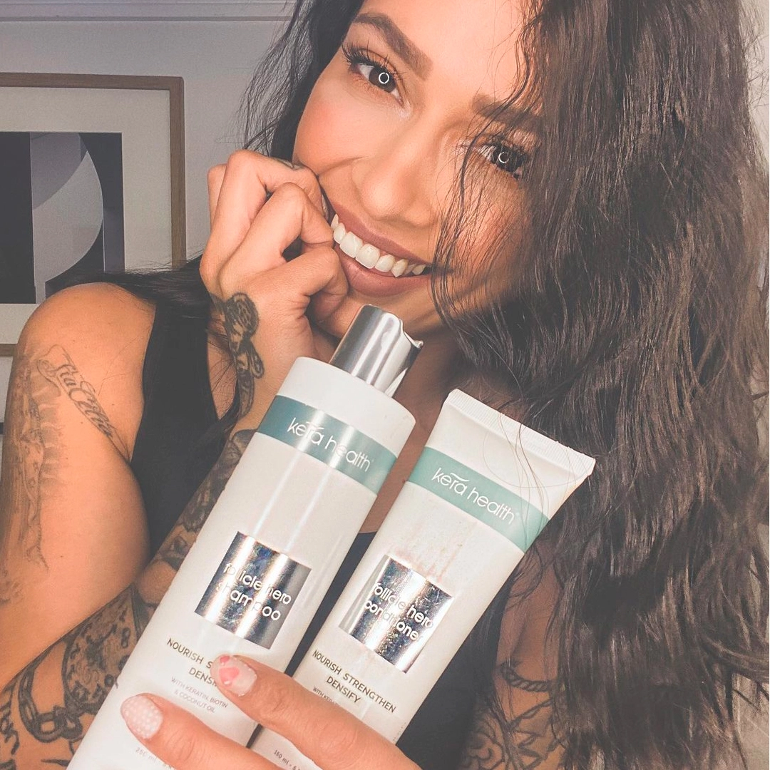 kera Health holding hair product