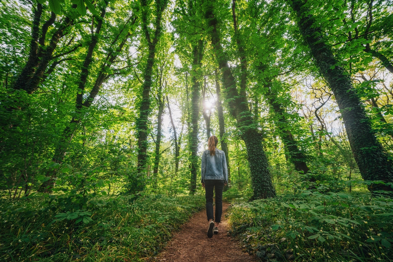 Woman walking alone when unplugging from society and technology