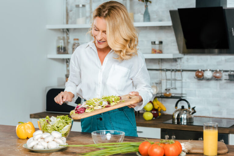 The longevity diet includes healthy foods; pic of woman cooking