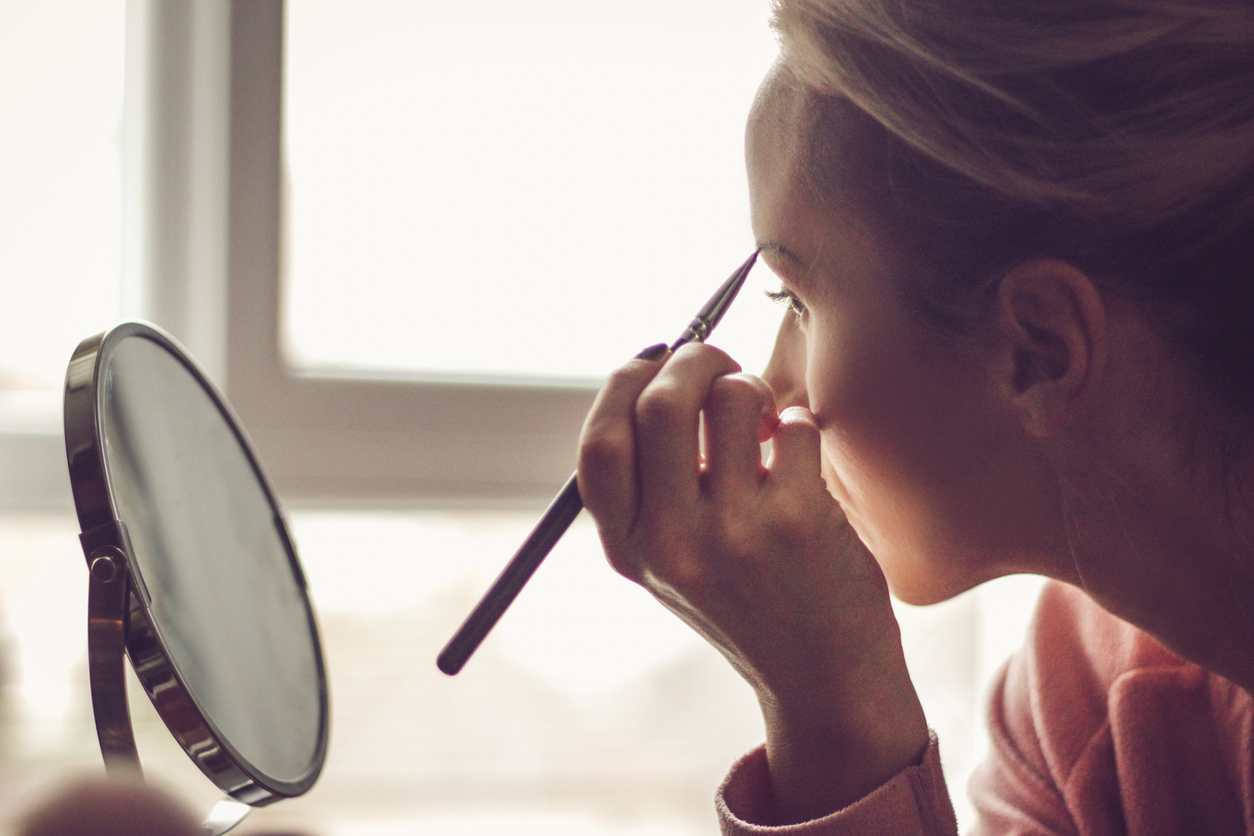 Woman using eyebrow makeup