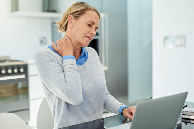 Woman with a sore neck or neck pain from text neck