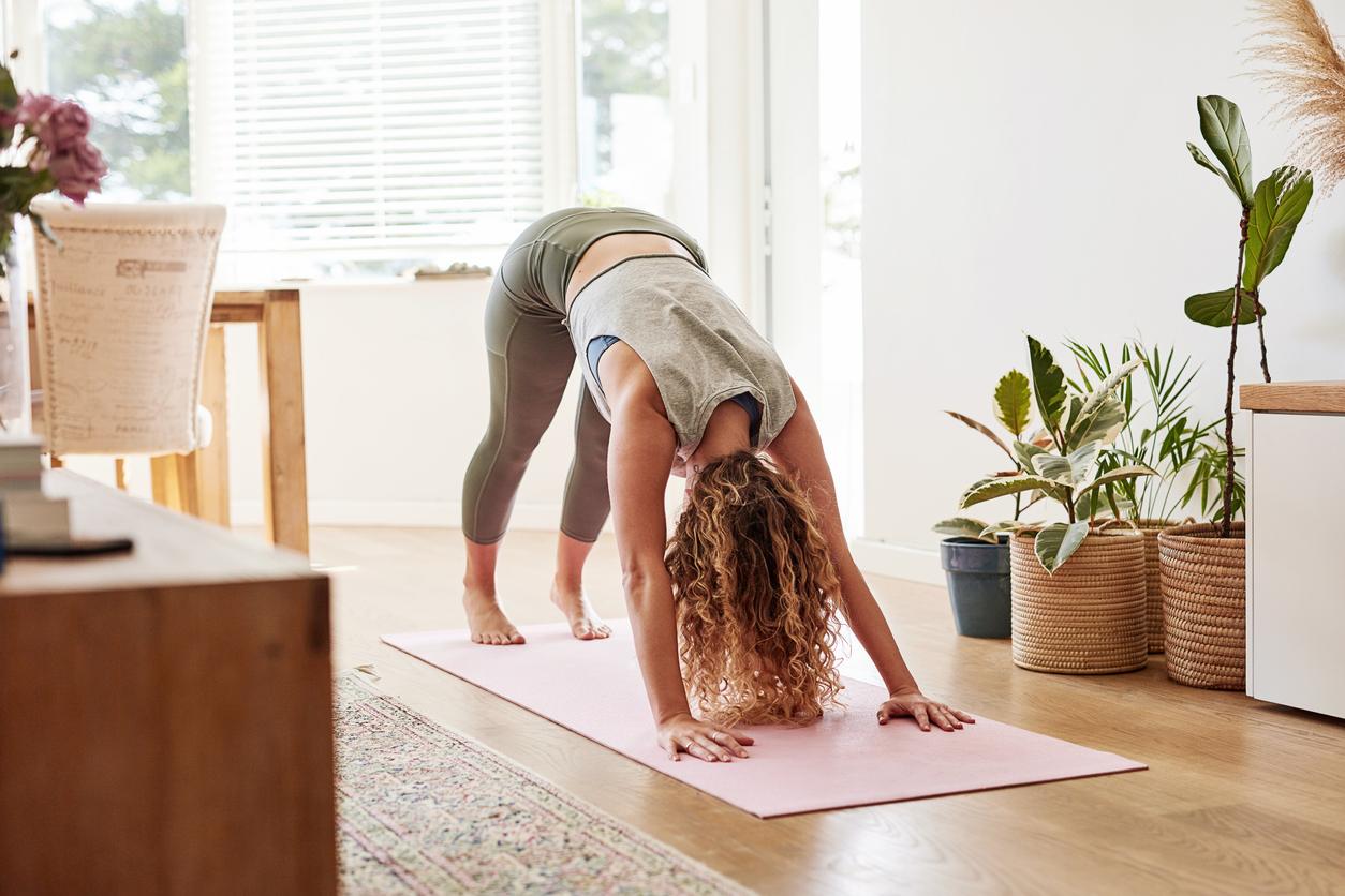 Woman doing yoga - downward dog