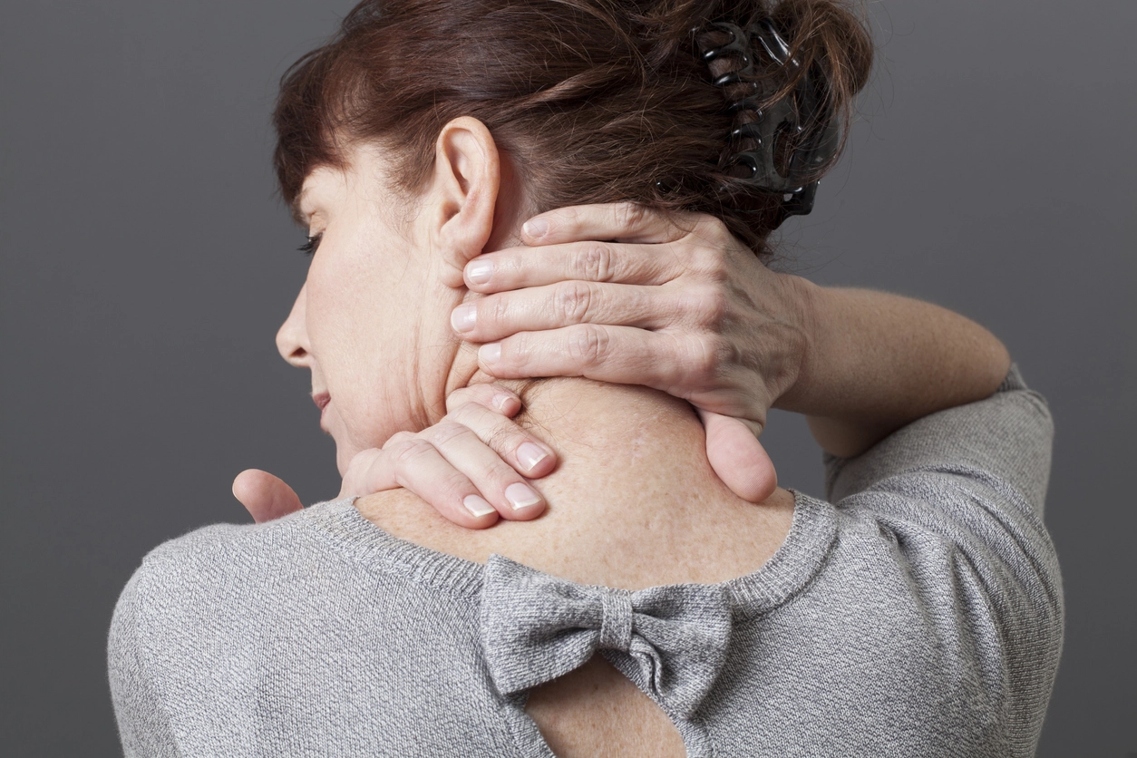 Woman rubbing neck from neck pain
