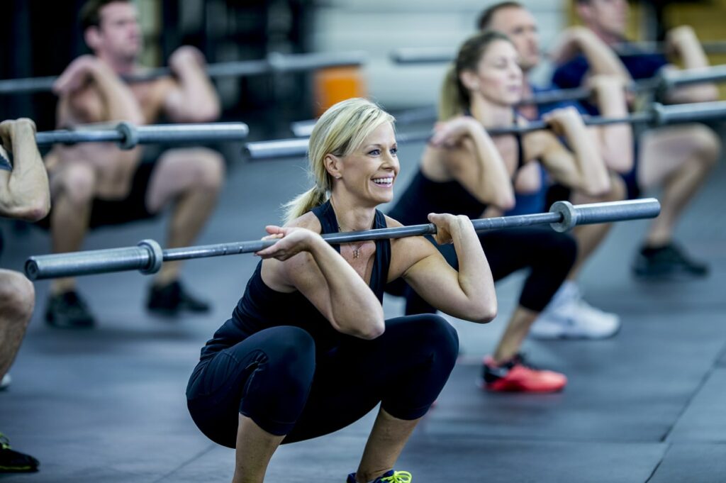 Muscle building workout - woman doing squats with a barbell