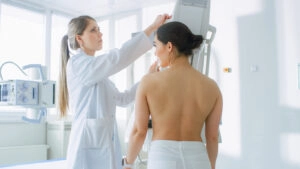 Woman getting a mammogram using a Bella Blankets for comfort and accuracy