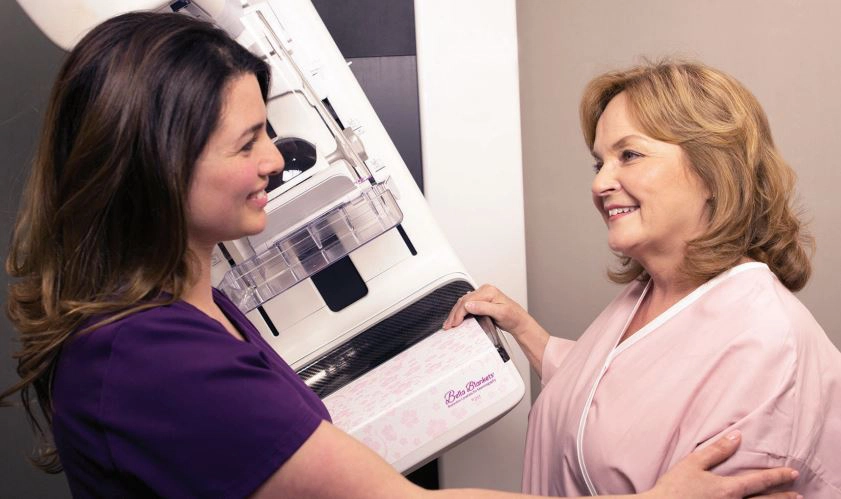 Bella blanket technician discussing with patient